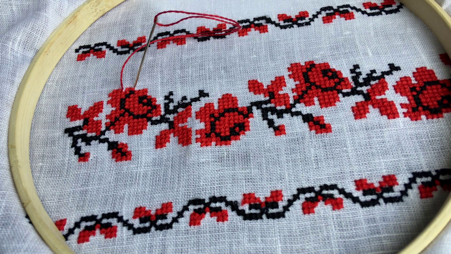 Embroidery Cross Stitch Patterns Hand Embroidery Cross Stitch Flower Ornament On A White Fabric In The Wooden Embroidery Hoop Top View Stock Video Footage Storyblocks Video